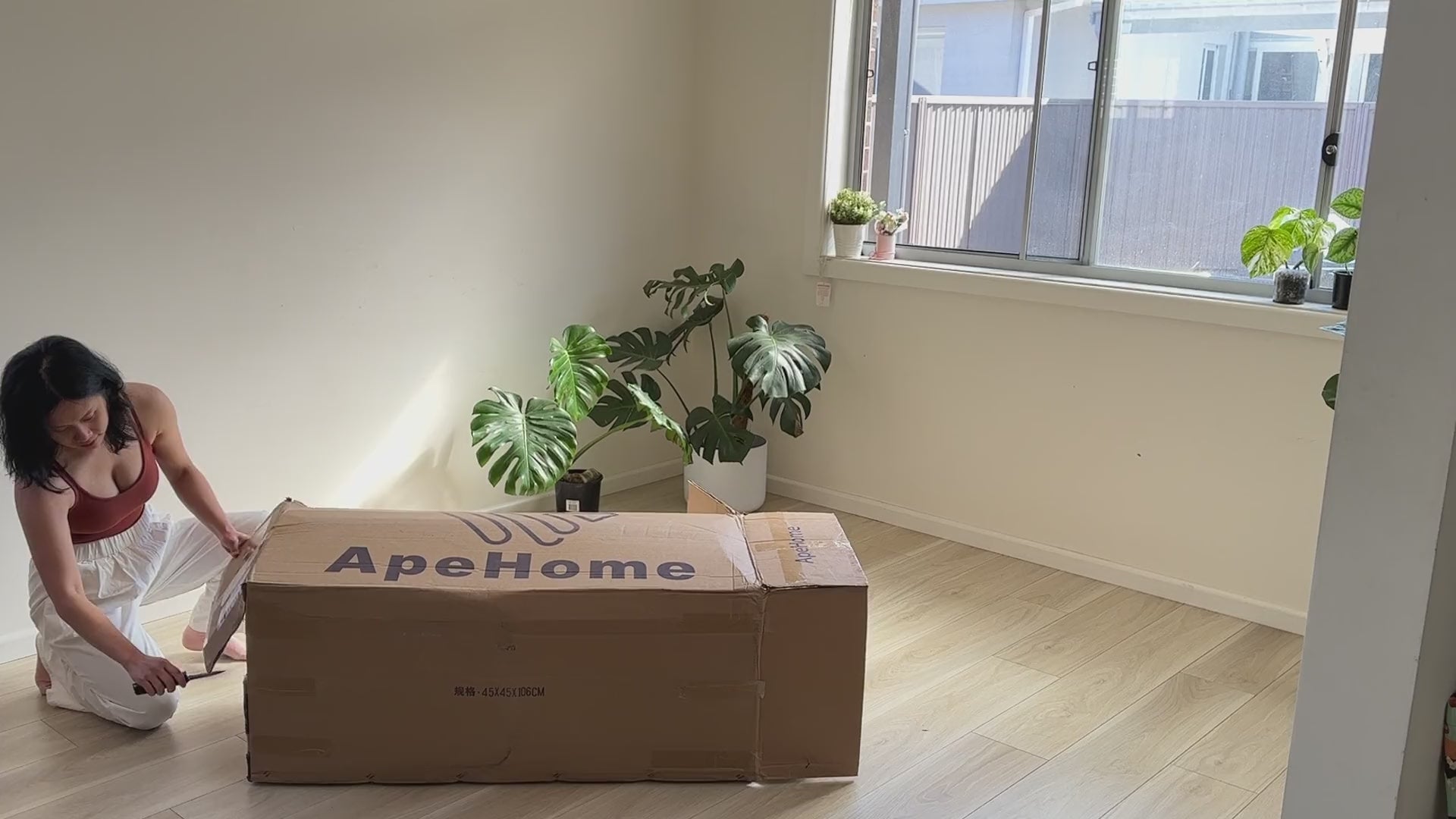Unboxing an Easovi sofa bed: cutting the box open, unrolling it, setting it up and sitting on the finished sofa